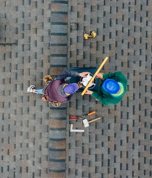 Close-up of shingle roof with roofing tools