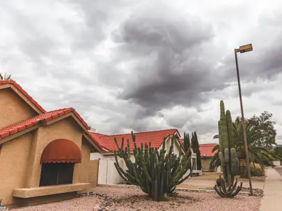 Storm clouds over Tucson tile roof homes